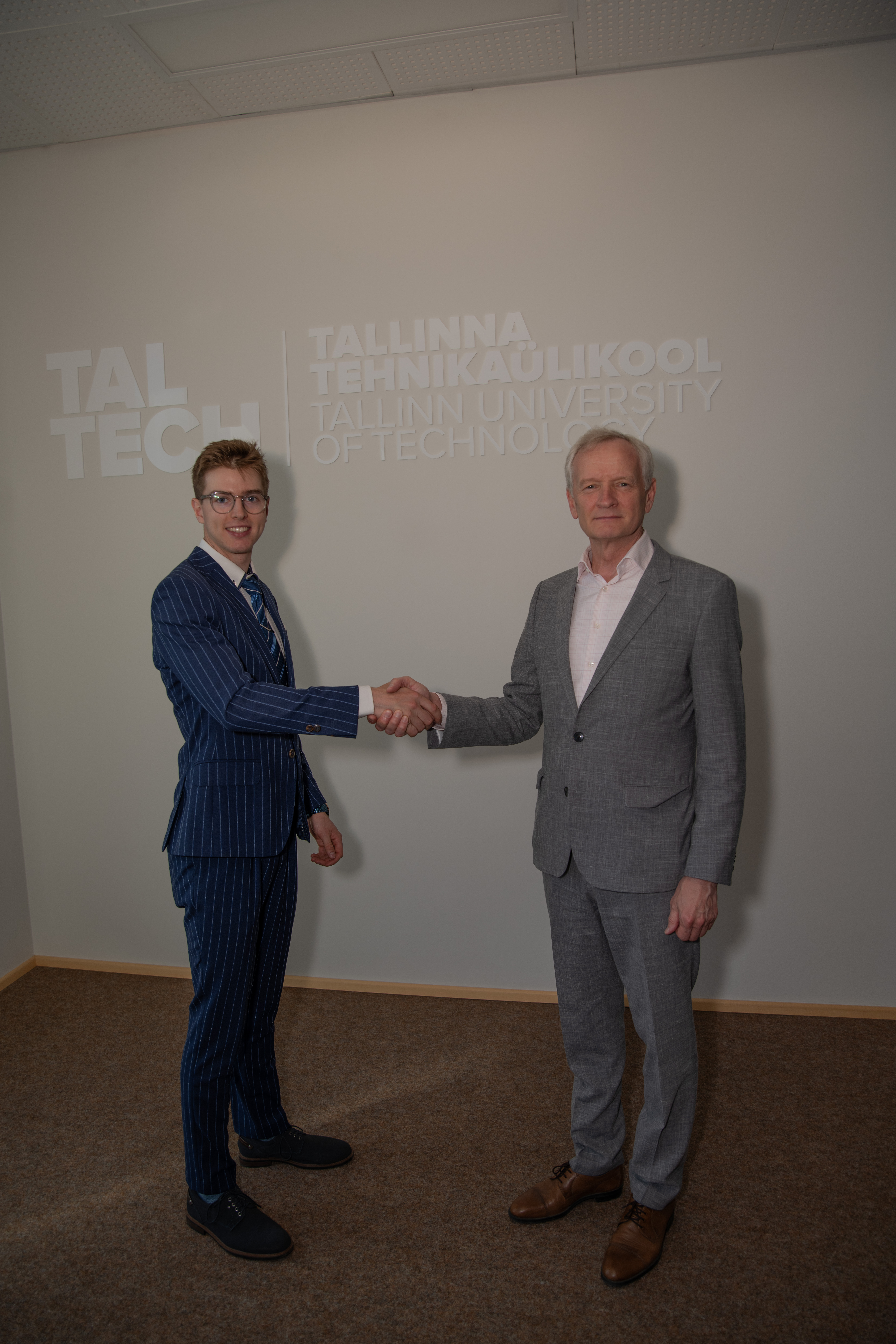 A handshake in front of the TalTech wall